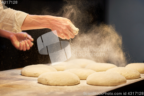 Image of chef or baker cooking dough at bakery