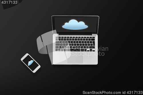 Image of laptop computer with cloud icon and smartphone