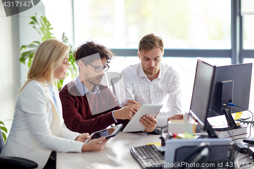 Image of business team with tablet pc at office