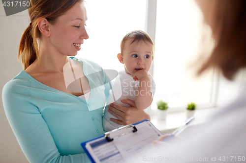 Image of happy woman with baby and doctor at clinic