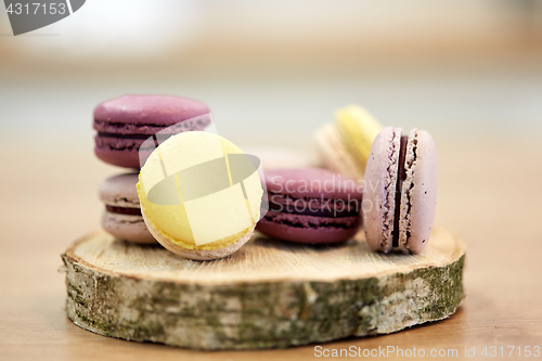 Image of different macarons on wooden stand