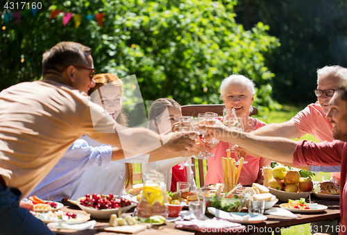 Image of happy family having dinner or summer garden party