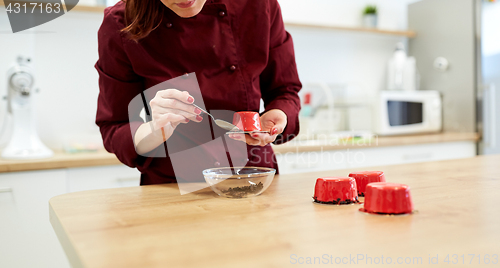 Image of chef decorating mirror glaze cakes at pastry shop