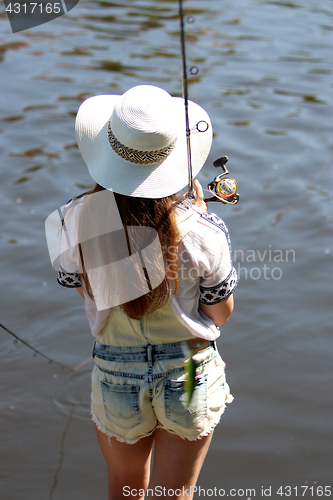 Image of Young woman with summer sprouts and dungarees