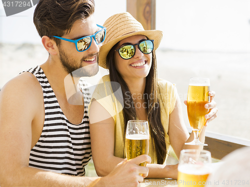 Image of Friends drinking a cold beer