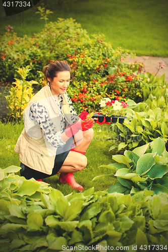 Image of middle-aged woman working in a flower garden