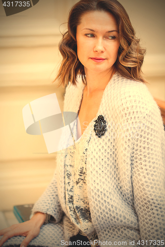 Image of beautiful woman in a light blue knitted coat