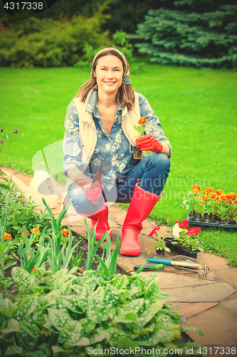 Image of woman working in a flower garden