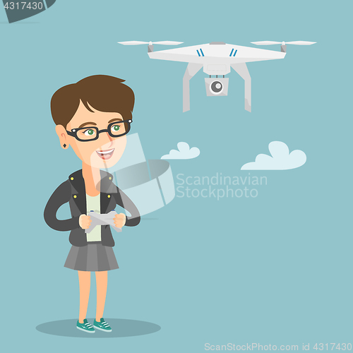 Image of Young caucasian woman flying drone.