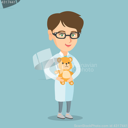 Image of Caucasian pediatrician doctor holding a teddy bear