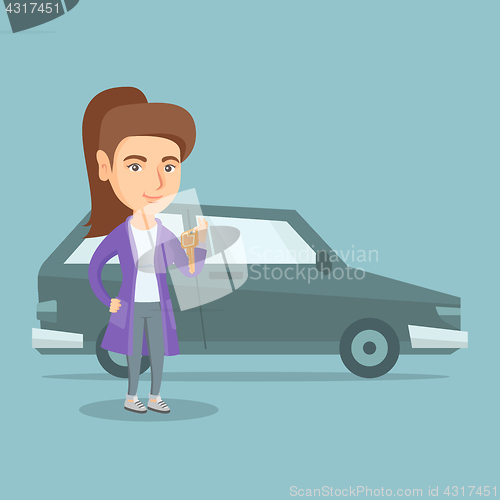 Image of Young caucasian woman holding keys to her new car.