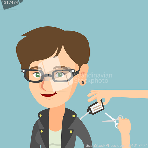 Image of Caucasian woman cutting price tag off new jacket.
