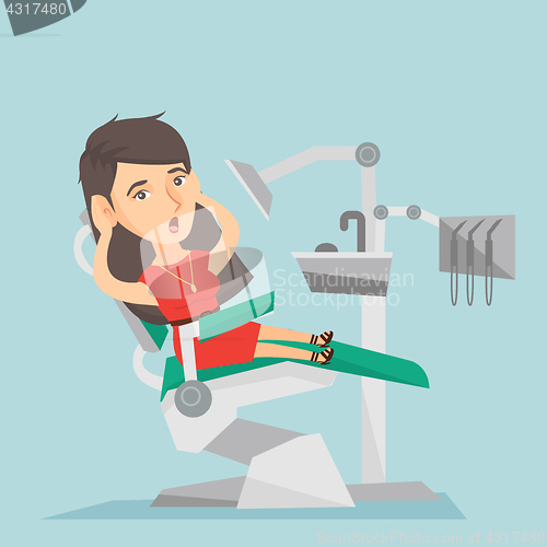 Image of Frightened woman sitting in a dental chair.