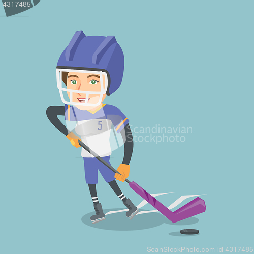 Image of Young caucasian ice hockey player with a stick.