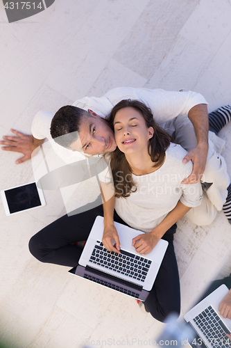 Image of couple using tablet and laptop computers top view