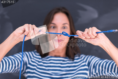 Image of woman holding a internet cable in front of chalk drawing board