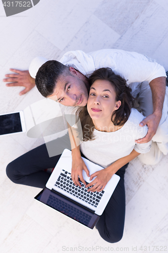 Image of couple using tablet and laptop computers top view