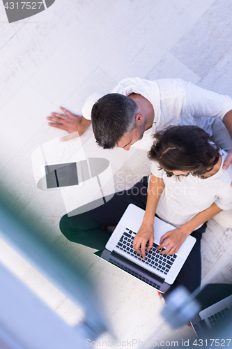 Image of couple using tablet and laptop computers top view