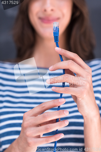 Image of woman holding a internet cable in front of chalk drawing board