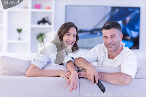 Image of Young couple on the sofa watching television