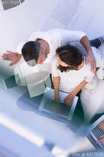 Image of couple using tablet and laptop computers top view