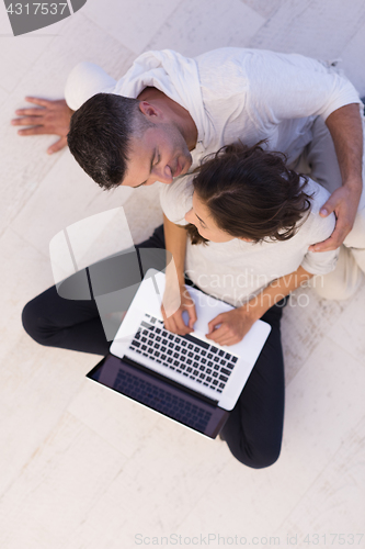 Image of couple using tablet and laptop computers top view