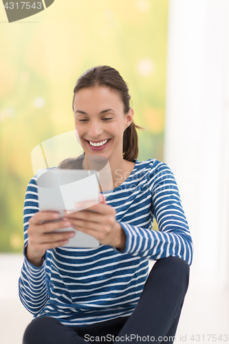 Image of young women using tablet computer on the floor