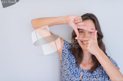 Image of woman showing framing hand gesture