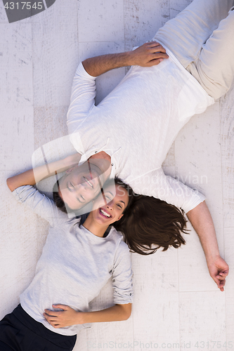 Image of handsome couple lying on floor