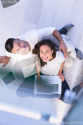 Image of couple using tablet and laptop computers top view