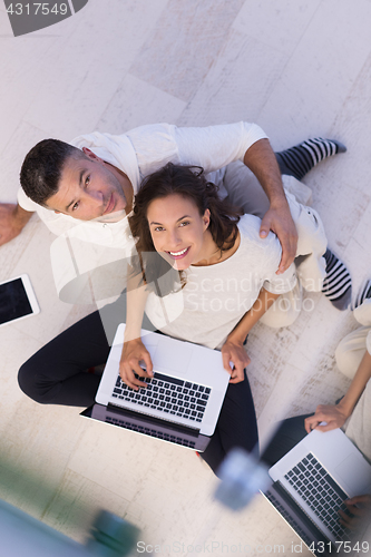 Image of couple using tablet and laptop computers top view