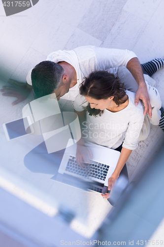 Image of couple using tablet and laptop computers top view