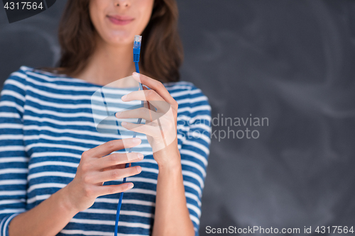 Image of woman holding a internet cable in front of chalk drawing board