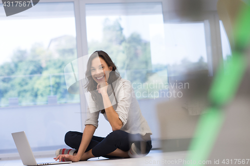 Image of young women using laptop computer on the floor