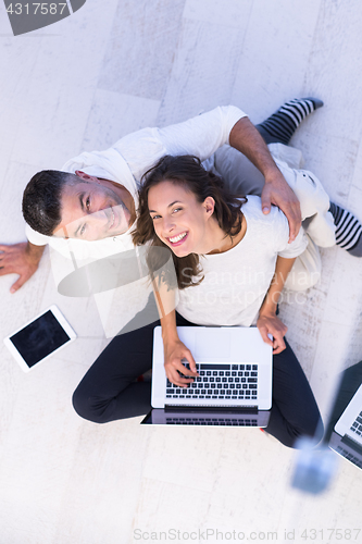 Image of couple using tablet and laptop computers top view