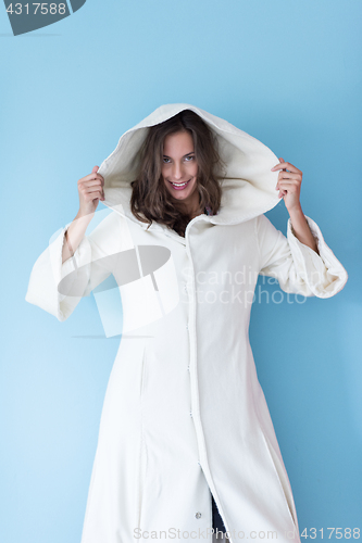 Image of woman in a white coat with hood isolated on blue background