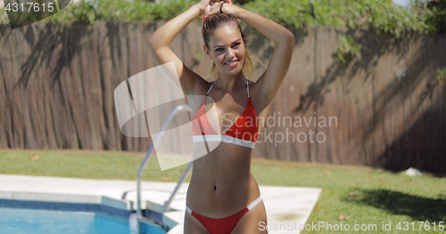 Image of Charming model in bikini posing happily