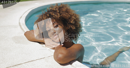 Image of Young girl posing in water of pool