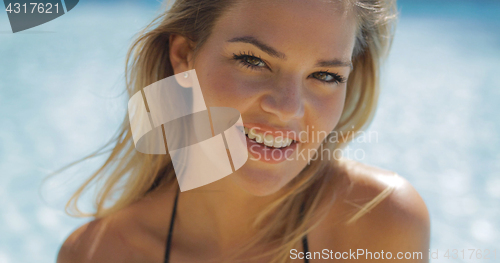 Image of Cheerful model posing in pool