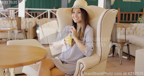 Image of Stylish elegant woman having drink