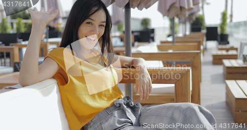 Image of Excited girl waving at camera