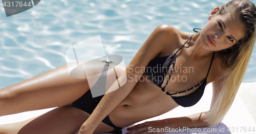 Image of Seductive model in bikini posing in pool