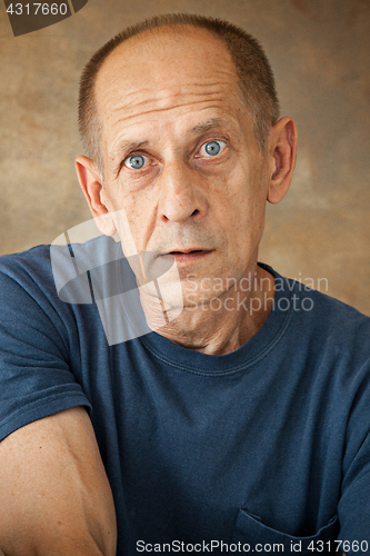 Image of Worried mature man sitting at studio