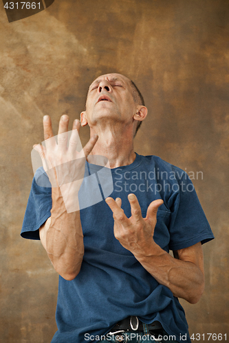 Image of Worried mature man standing at studio