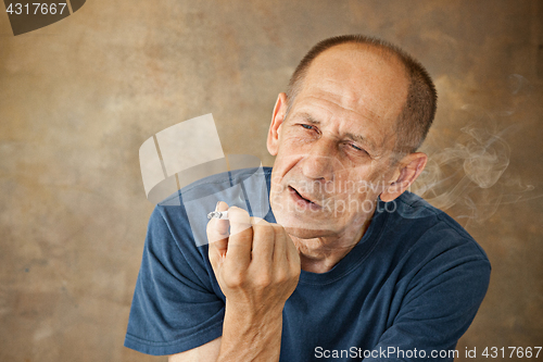 Image of Worried mature man sitting at studio