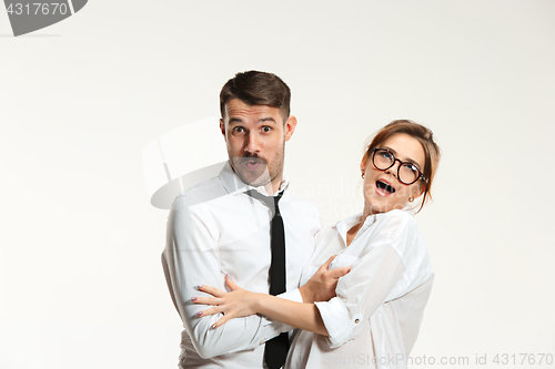 Image of The business man and woman communicating on a gray background