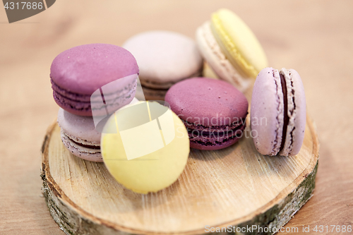 Image of different macarons on wooden stand