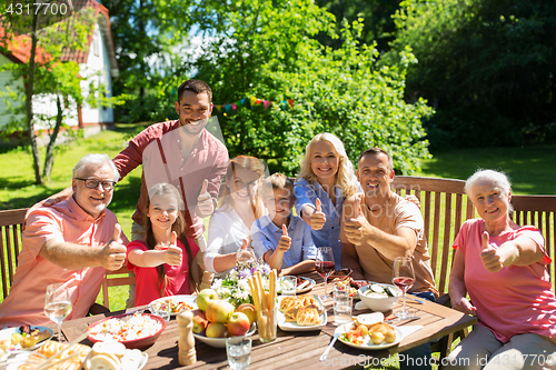 Image of happy family having dinner or summer garden party