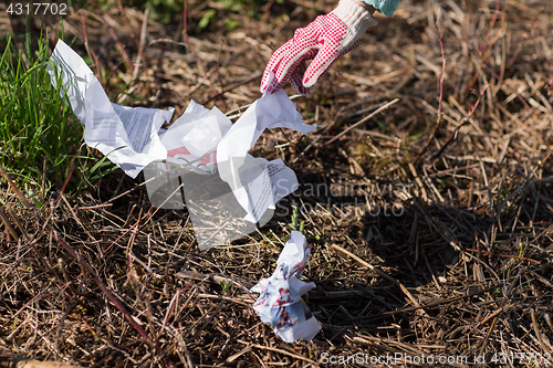 Image of volunteer hand cleaning area from garbage