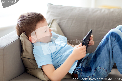 Image of little boy with tablet pc computer at home